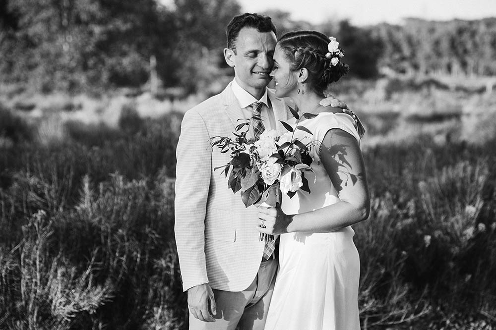 A documentary portrait of a bride and room snuggling during their Boston wedding
