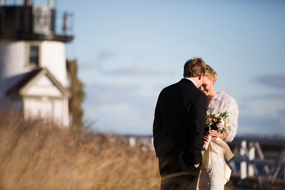 A documentary portrait of a bride and groom snuggling during their Nantucket wedding