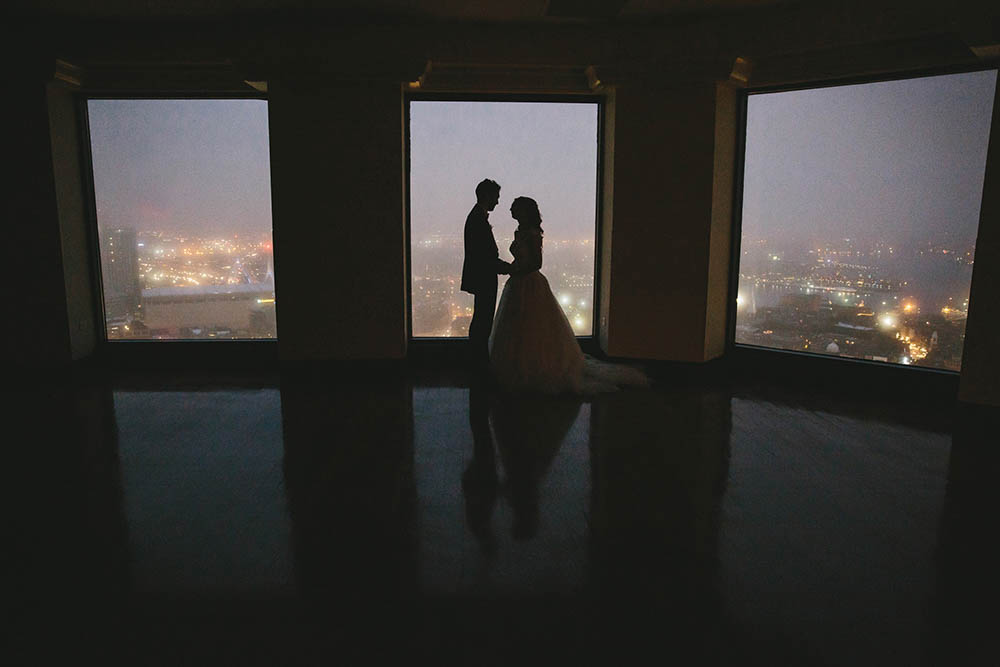 A documentary photograph of a bride and groom sharing an intimate moment during their State Room wedding in Boston