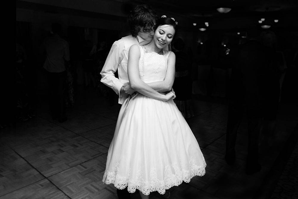 A documentary photograph of a bride and groom dancing during their Boston Wedding
