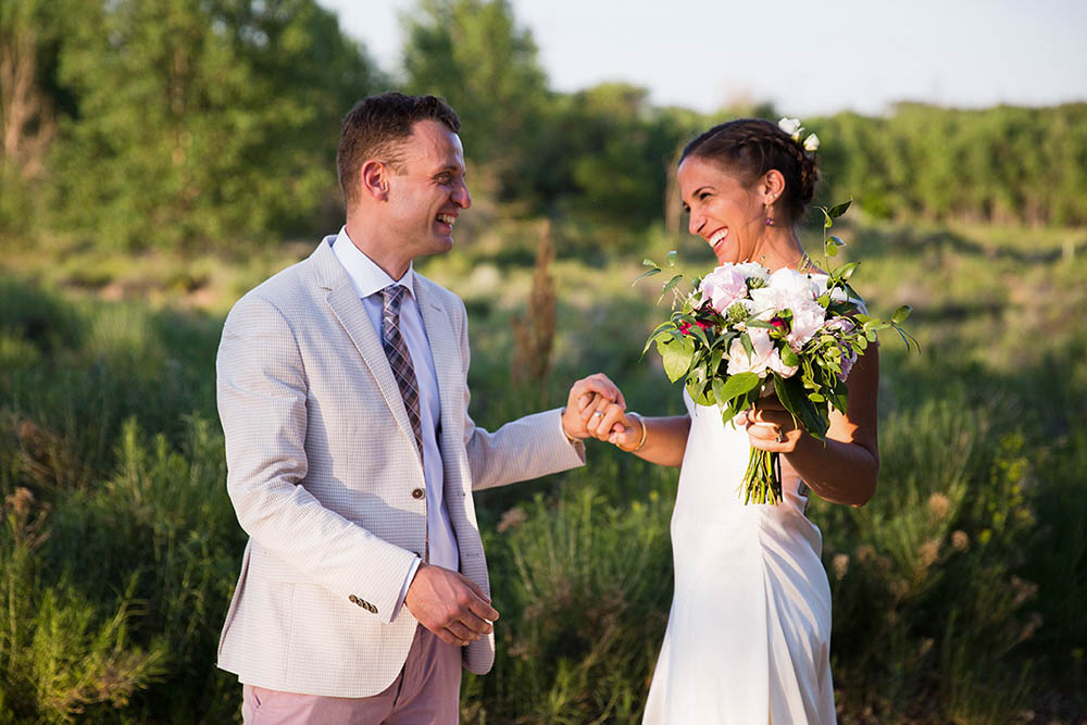 A documentary portrait of a bride and groom laughing during their Boston wedding