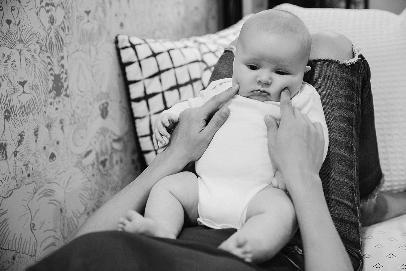 A documentary photograph of a mother with her son during an in home family session in Boston