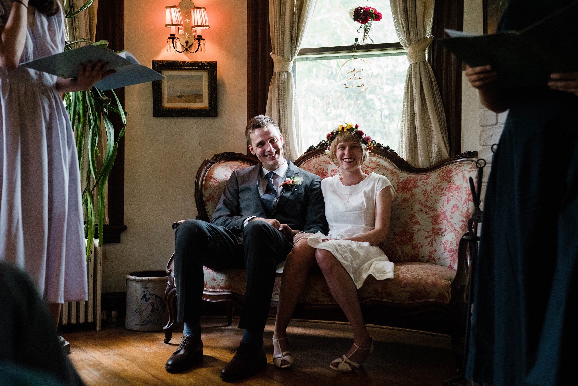 A documentary photograph featured in the best of wedding photography of 2019 showing a couple laughing during their intimate wedding ceremony at home