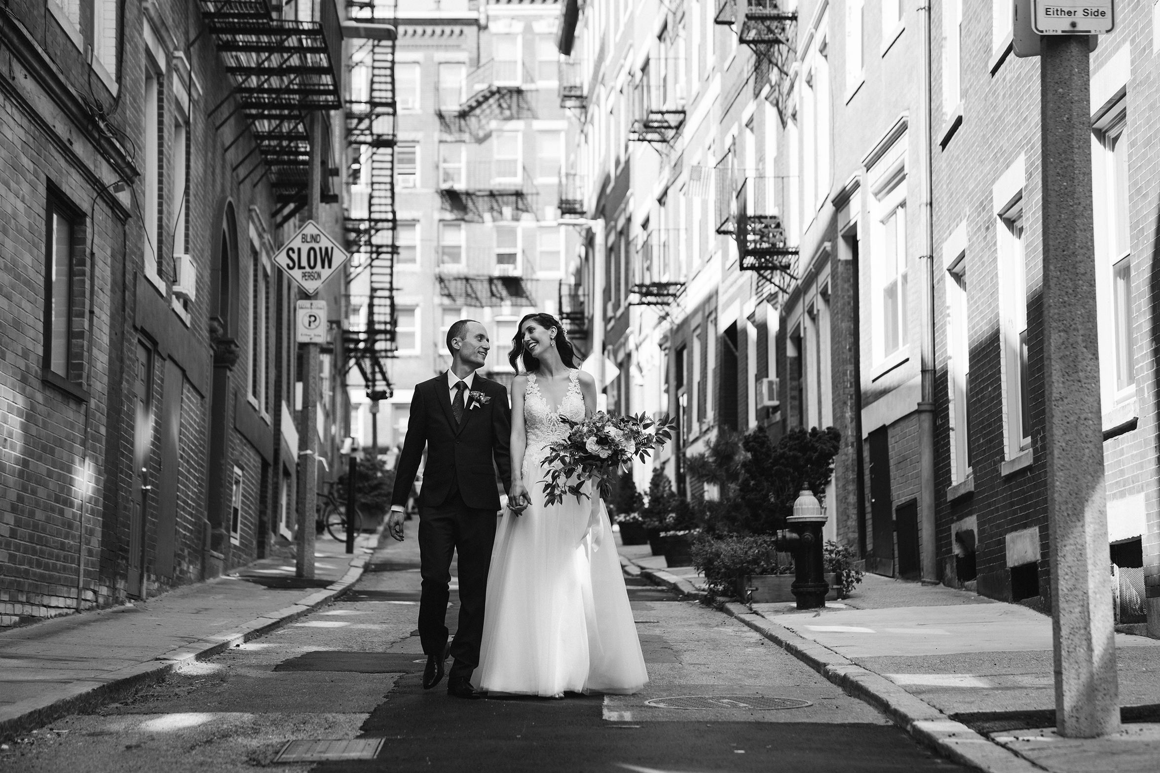 A documentary photograph featured in the best of wedding photography of 2019 showing a couple walking down the street after their wedding ceremony in the North End
