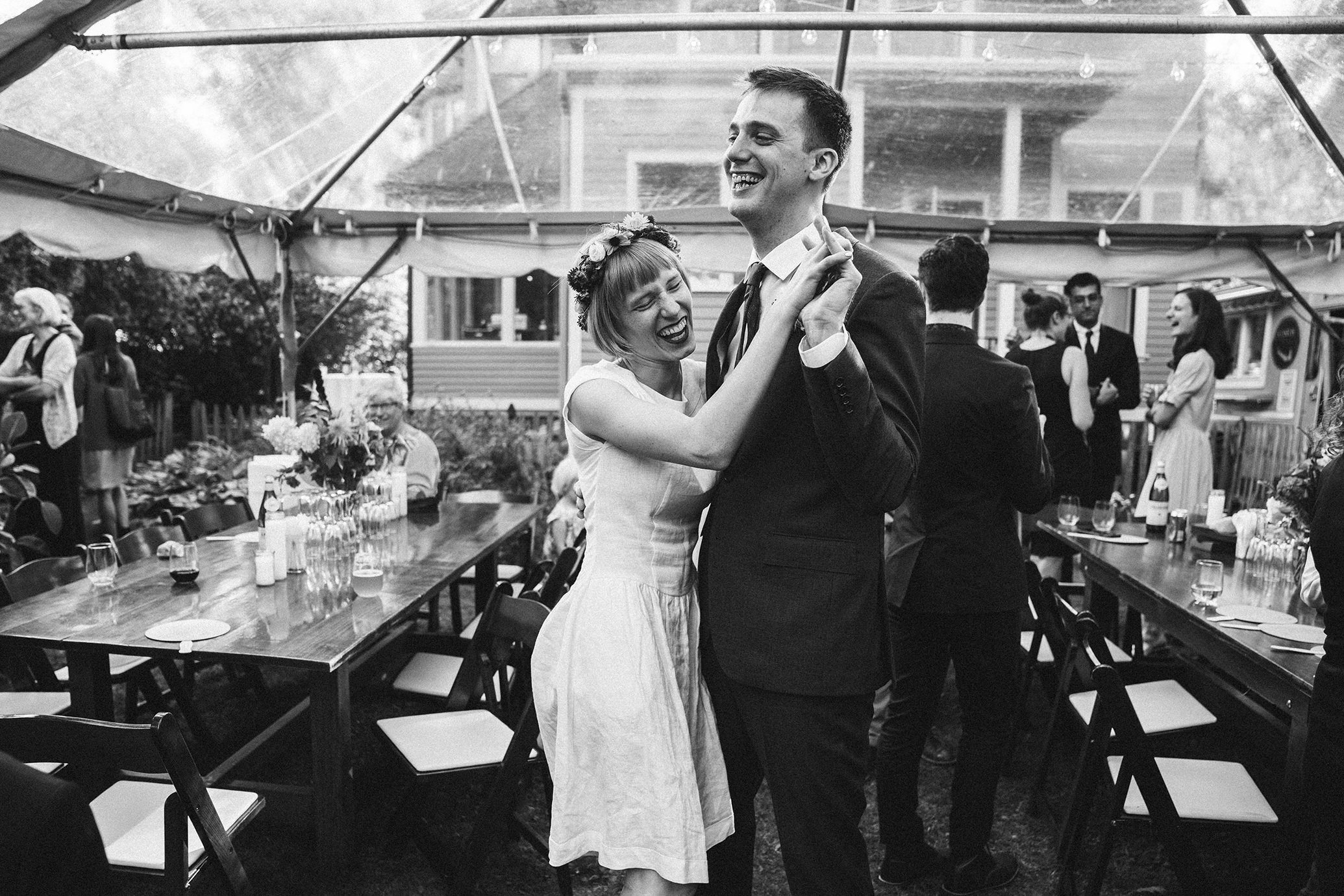 A documentary photograph featured in the best of wedding photography of 2019 showing a couple sharing their first dance during their backyard wedding