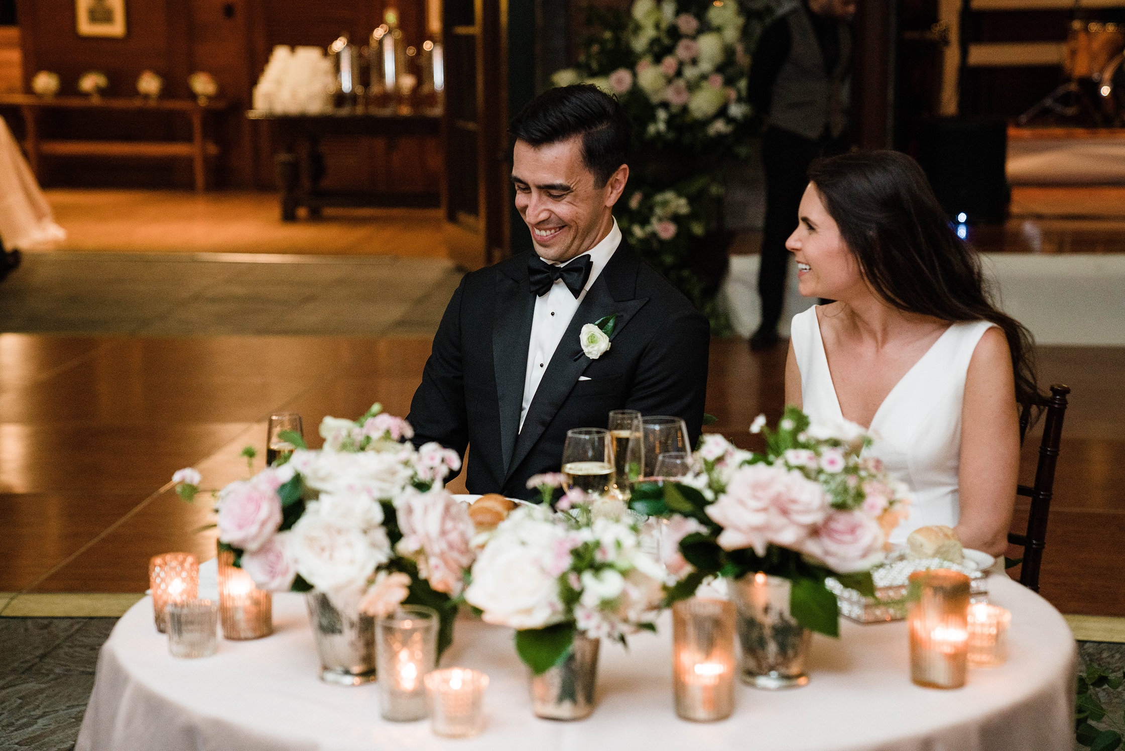 A documentary photograph featured in the best of wedding photography of 2019 showing a couple laughing during their wedding toasts