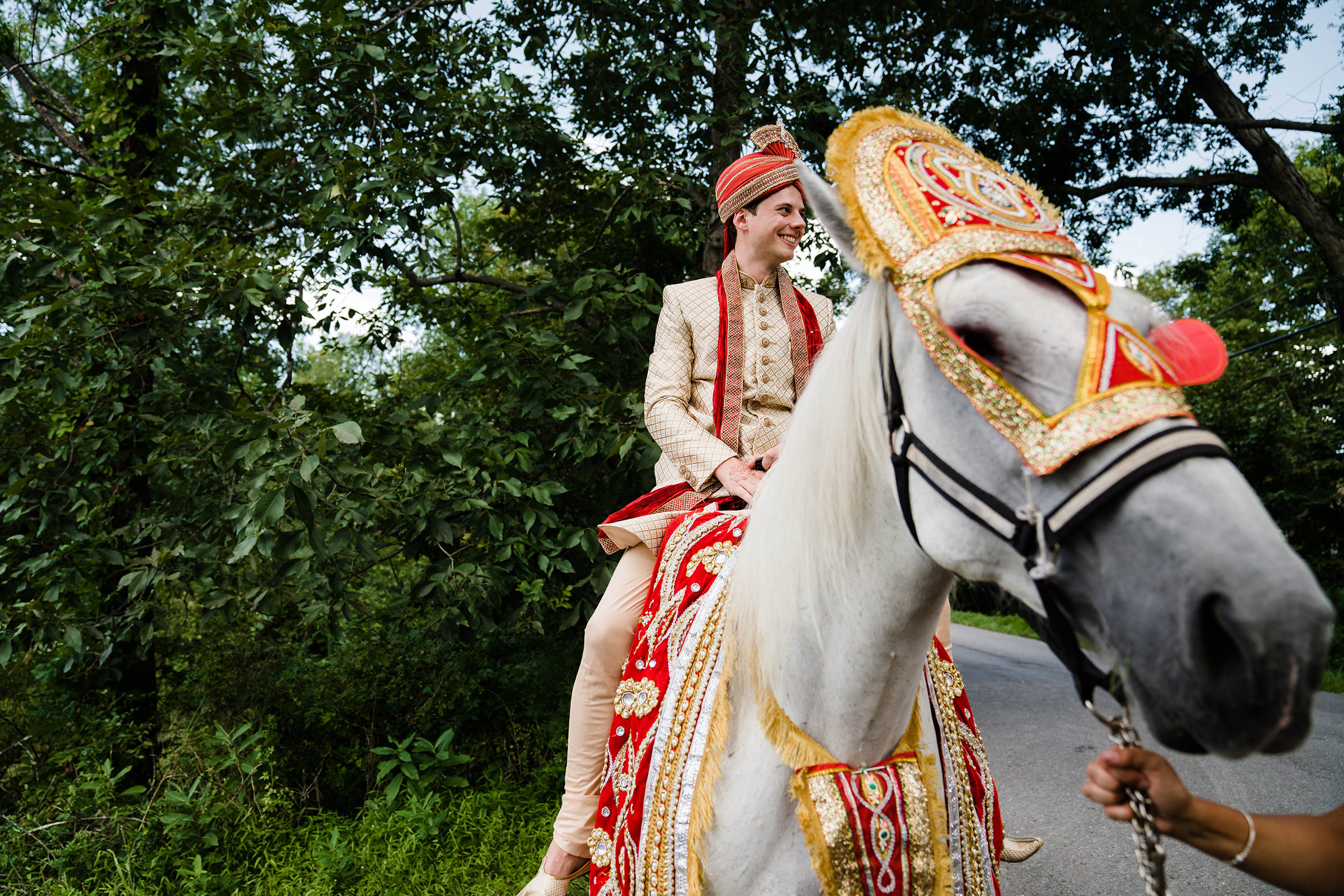 A documentary photograph featured in the best of wedding photography of 2019 showing the groom on a horse during the baraat 
