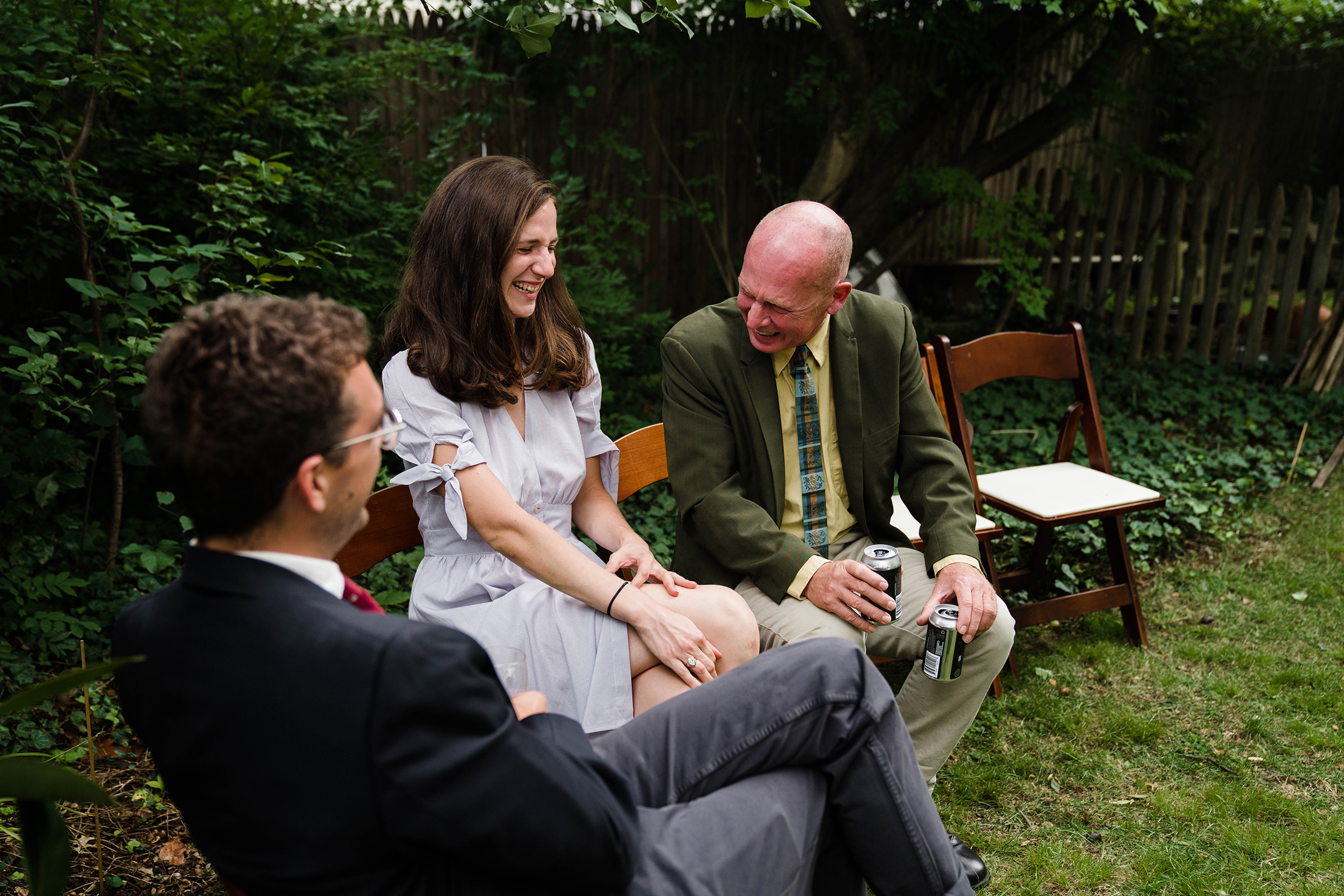 A documentary photograph featured in the best of wedding photography of 2019 showing wedding guests laughing during a backyard wedding reception
