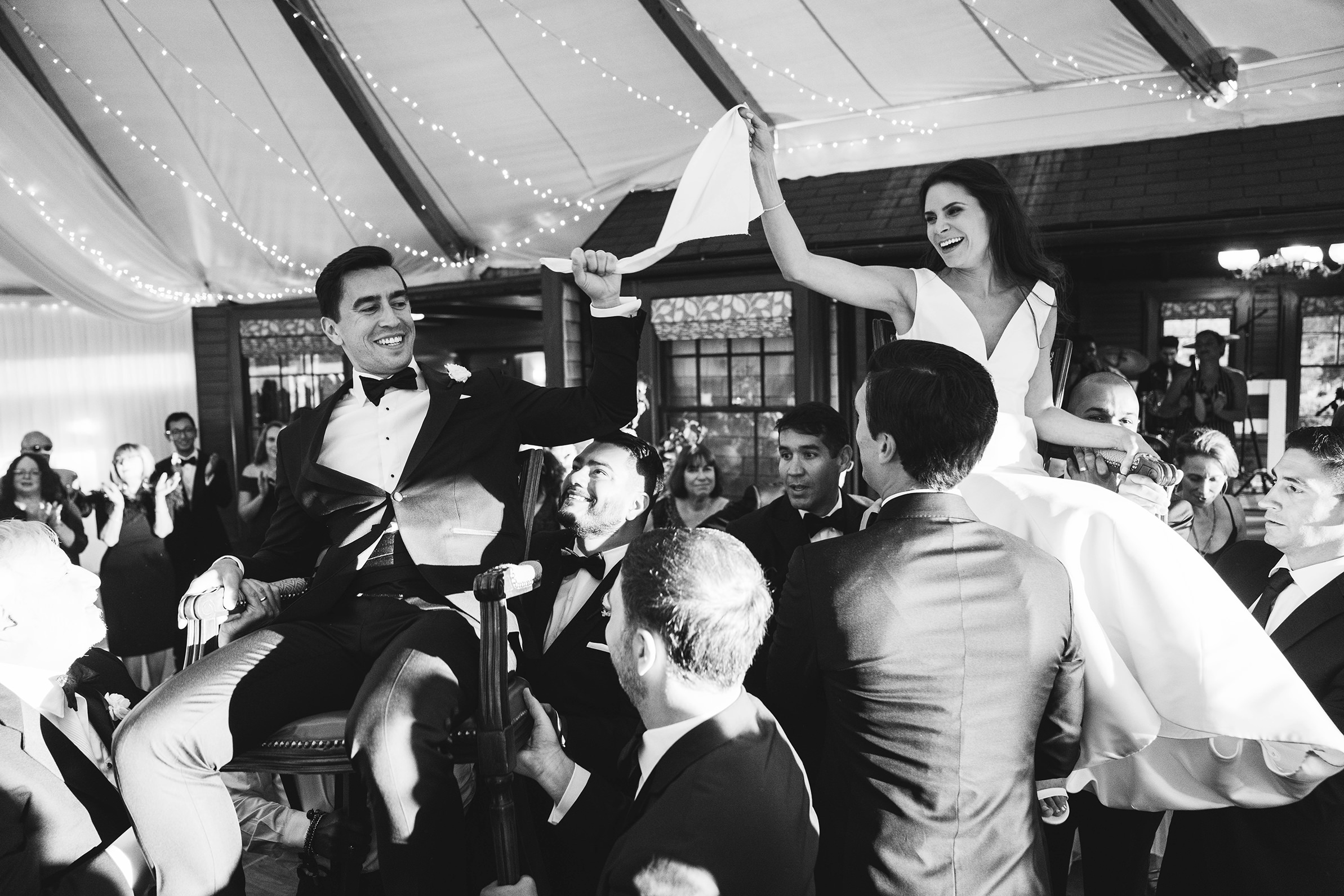 A documentary photograph featured in the best of wedding photography of 2019 showing a bride and groom dancing during the hora