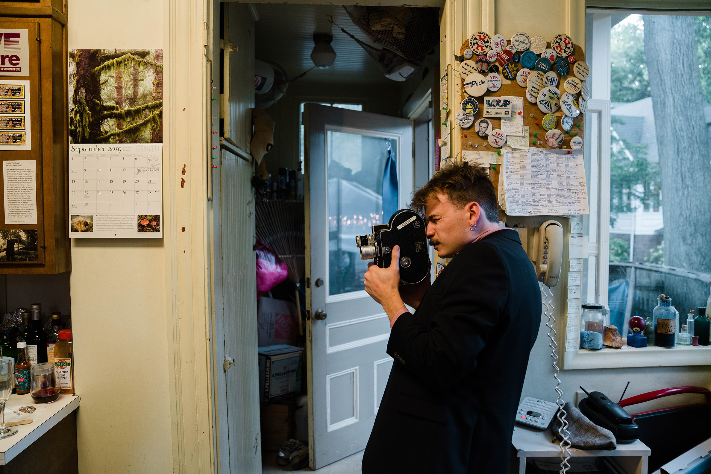 A documentary photograph featured in the best of wedding photography of 2019 showing a wedding guest filming the wedding
