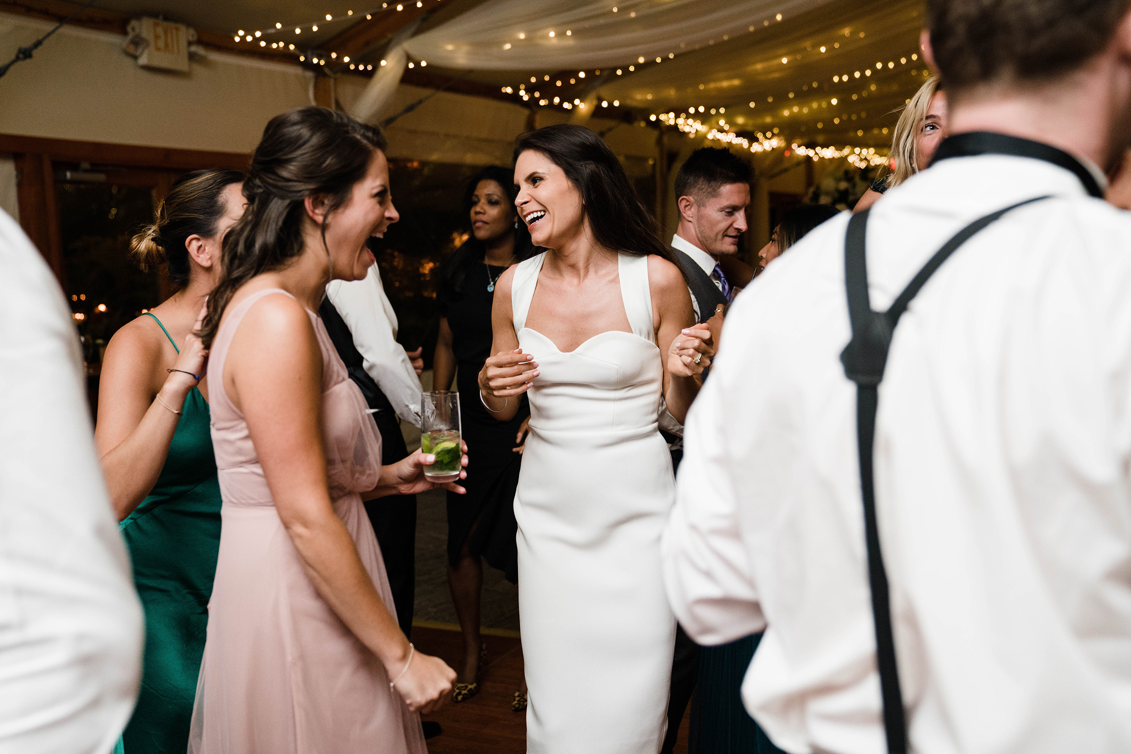 A documentary photograph featured in the best of wedding photography of 2019 showing a bride dancing with friends
