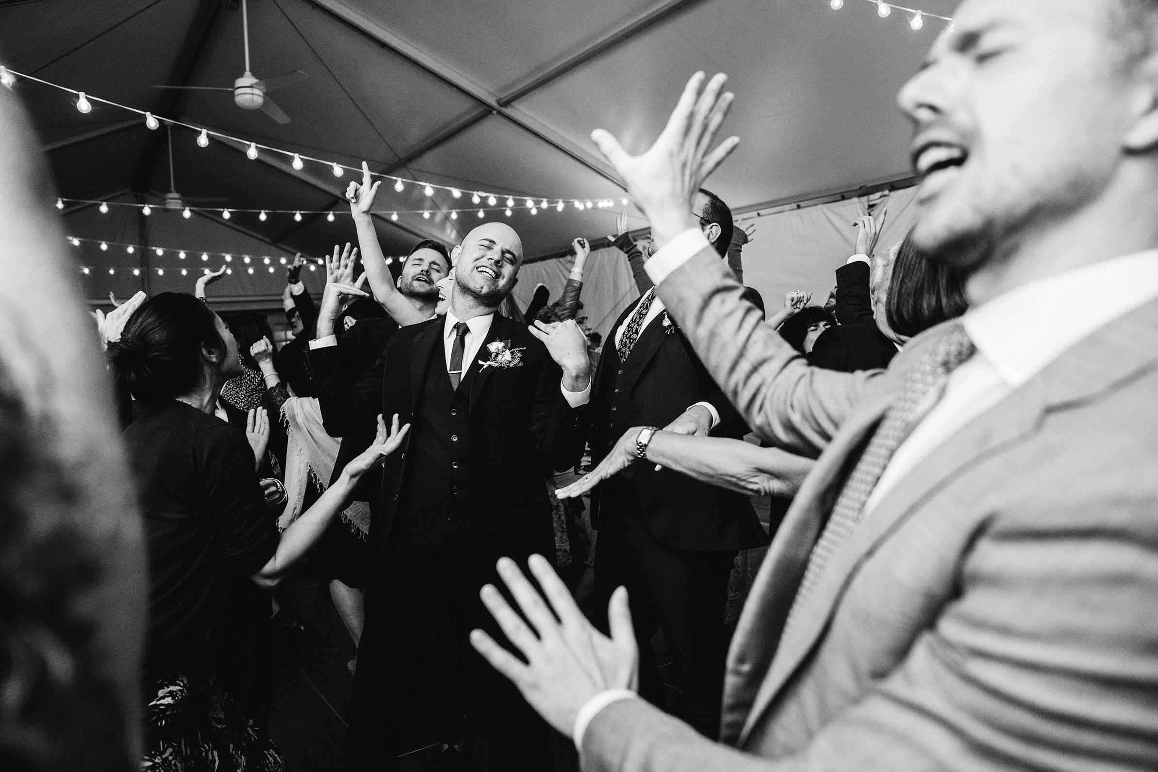 A documentary photograph featured in the best of wedding photography of 2019 showing guests dancing