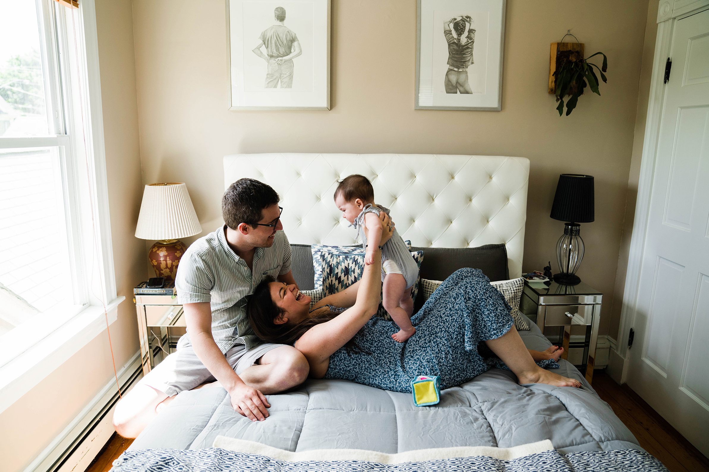 A best of Boston family photograph of a family laughing together in bed during an in home family session in Boston