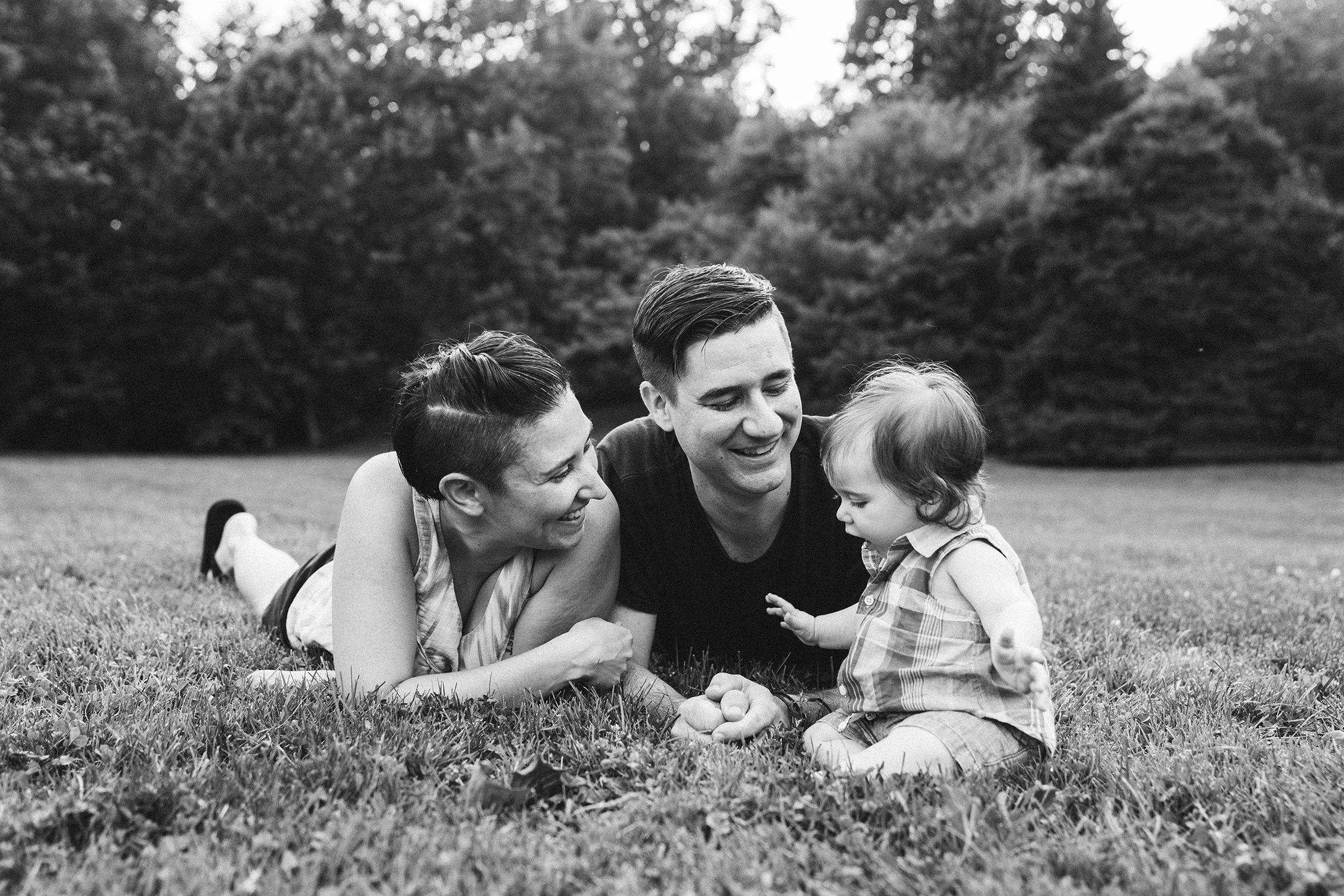 A documentary photograph of family playing in the grass during their family session in Boston