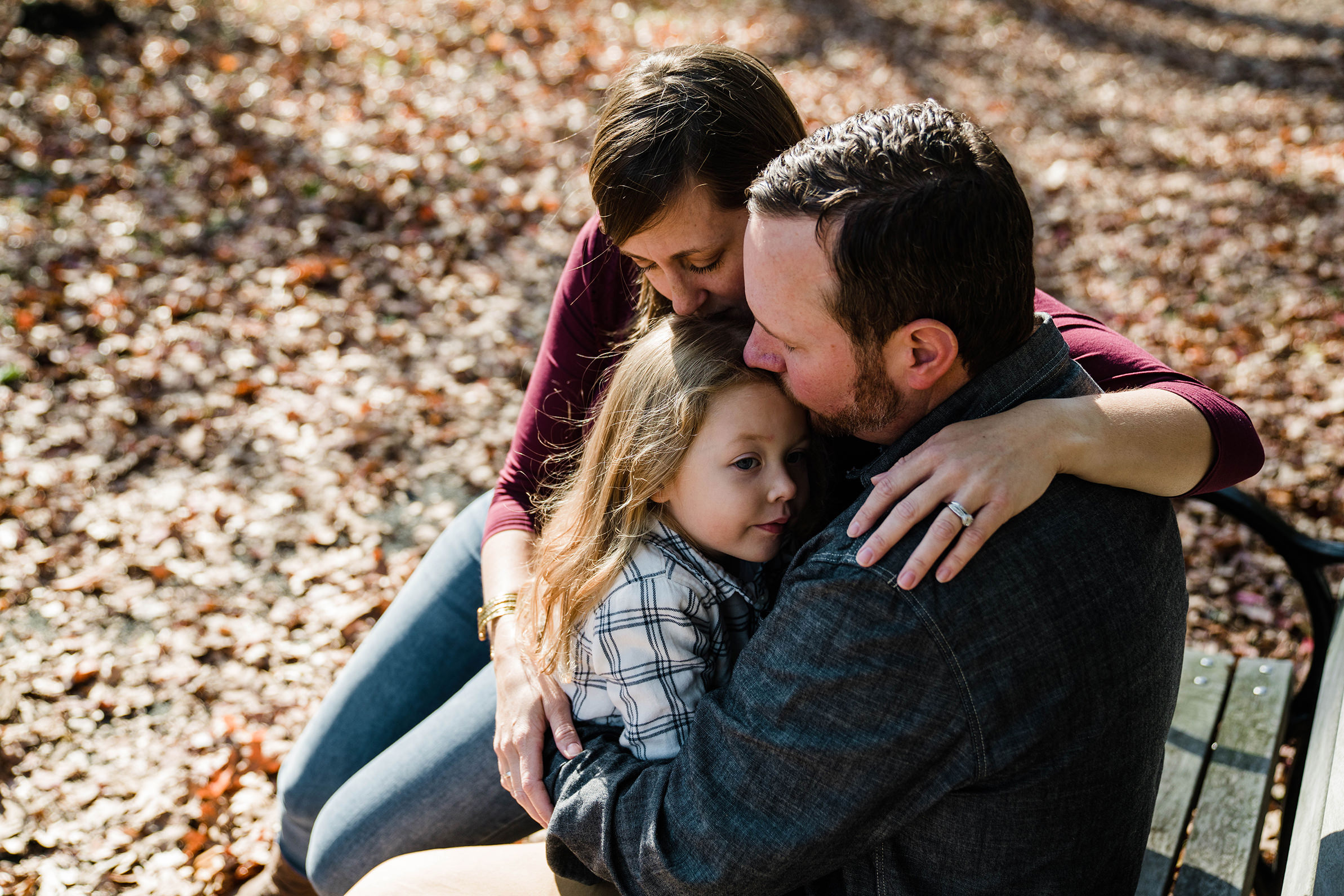 A documentary photograph of family snuggling together during an family photo session in Boston